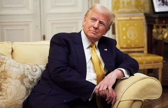Дональд Трамп во время интервью на фоне флага США