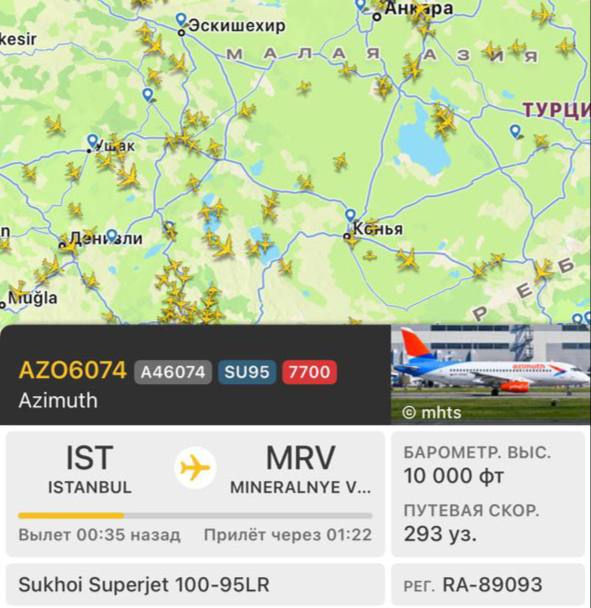 Самолет Sukhoi Superjet 100 в небе над морем
